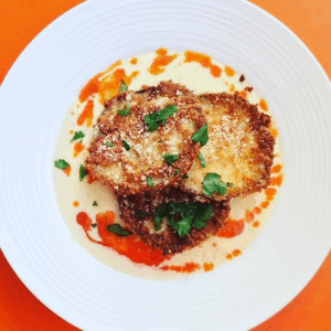Fried eggplant with mornay cream sauce and buffalo hot sauce.